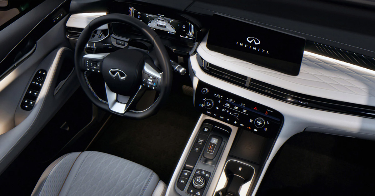 The interior of the INFINITI QX60 showing the steering wheel and infotainment system