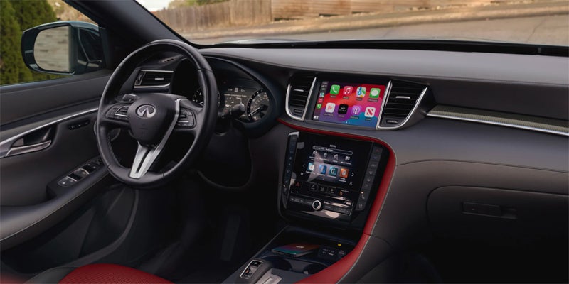 Modern car interior featuring a steering wheel and dual touchscreen displays