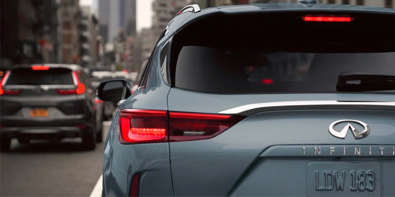 Rear view of a silver SUV showing the logo and taillight